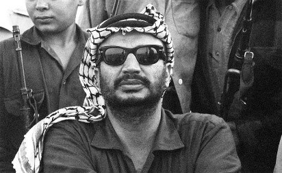 Man with sunglasses and keffiyeh among others