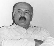 Black and white photo of a man with mustache.